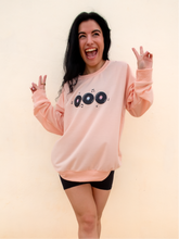 Load image into Gallery viewer, peach crewneck sweatshirt with 3 records that have music notes surrounding them printed on the front, and a colorful disco ball with the phrase "do a little happy dance" printed on the back