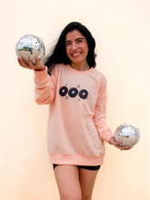 Load image into Gallery viewer, peach crewneck sweatshirt with 3 records that have music notes surrounding them printed on the front, and a colorful disco ball with the phrase "do a little happy dance" printed on the back