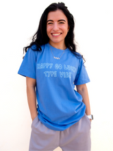 Load image into Gallery viewer, Blue graphic t-shirt with a whimsical "happy go lucky type vibe" design.