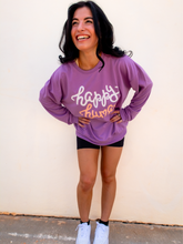 Load image into Gallery viewer, Young lady modeling a purple lightweight, crewneck sweatshirt with a hand-lettered script design saying "happy human" on the front in white and peach.