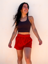 Load image into Gallery viewer, Young lady modeling a dark gray cropped racerback spandex tank with a built-in sports bra.