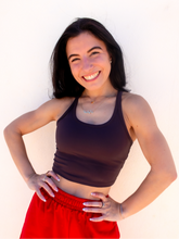 Load image into Gallery viewer, Young lady modeling a dark gray cropped racerback spandex tank with a built-in sports bra.