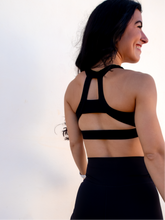 Load image into Gallery viewer, Black sports bra has a slightly higher neck and thick strappy back to provide great comfort and high support.