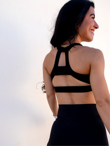 Black sports bra has a slightly higher neck and thick strappy back to provide great comfort and high support.