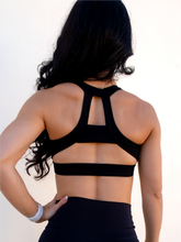 Load image into Gallery viewer, Black sports bra has a slightly higher neck and thick strappy back to provide great comfort and high support.