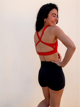 Load image into Gallery viewer, Form fitting, high waisted, black spandex shorts with a criss cross waistband.