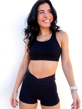 Load image into Gallery viewer, Form fitting, high waisted, black spandex shorts with a criss cross waistband.