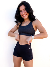 Load image into Gallery viewer, Form fitting, high waisted, black spandex shorts with a criss cross waistband.