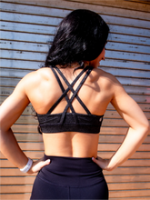 Load image into Gallery viewer, Heathered grey sports bra with medium support, removable pads and a criss cross back