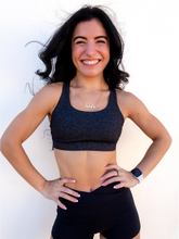 Load image into Gallery viewer, Heathered grey sports bra with medium support, removable pads and a criss cross back
