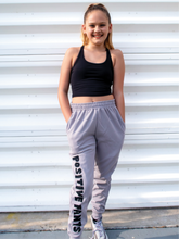 Load image into Gallery viewer, Peachy Pia Positive Pants joggers. Grey lightweight jogger sweatpants with positive pants design down the front of the right leg and smiley face design on the back pocket. Joggers provide an elastic waist and cuffed ankles.