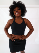 Load image into Gallery viewer, The black Peachy tank is a comfortable cropped tank top with a built in sports bra made for everyday wear.