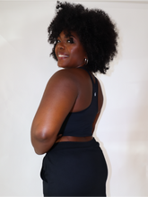 Load image into Gallery viewer, The black Peachy tank is a comfortable cropped tank top with a built in sports bra made for everyday wear.