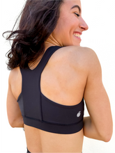 Load image into Gallery viewer, Lady modeling unique style black racerback sports bra.