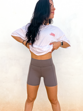 Load image into Gallery viewer, Young lady modeling comfortable, soft and stretchy grey biker shorts