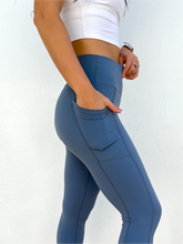 Load image into Gallery viewer, The Serenity Leggings are buttery-soft, high waisted, cropped leggings in a dusty blue color.