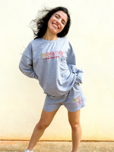 Load image into Gallery viewer, Grey crewneck sweatshirt with multicolor smiley face embroidered design.