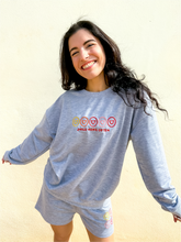 Load image into Gallery viewer, Grey crewneck sweatshirt with multicolor smiley face embroidered design.