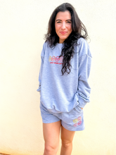 Load image into Gallery viewer, Grey, lightweight sweatshorts with multicolored smiley faces embroidered.