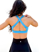 Load image into Gallery viewer, Lady modeling sky blue strappy sports bra.