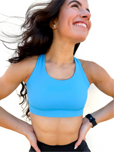 Load image into Gallery viewer, Lady modeling sky blue strappy sports bra.