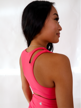 Load image into Gallery viewer, Pink Split Sports Bra has a standard racerback style with a slit on the upper right shoulder area. High support.