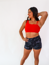 Load image into Gallery viewer, The Striking Sports Bra is a one shoulder, apple red sports bra with additional straps for added support and comes in a creamy soft material.