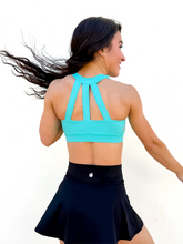 Load image into Gallery viewer, Lady modeling turquoise sporta bra with strappy back.