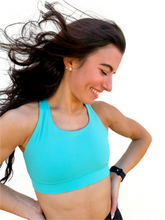 Load image into Gallery viewer, Lady modeling turquoise sporta bra with strappy back.