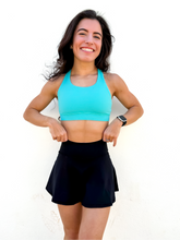 Load image into Gallery viewer, Lady modeling turquoise sporta bra with strappy back.