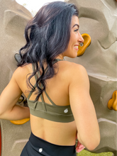 Load image into Gallery viewer, Army green sports bra with medium support, removable pads and a criss cross back