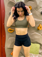 Load image into Gallery viewer, Army green sports bra with medium support, removable pads and a criss cross back