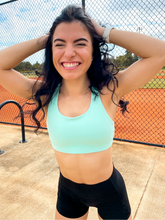 Load image into Gallery viewer, Tiffany Blue sports bra with medium support, removable pads and a criss cross back