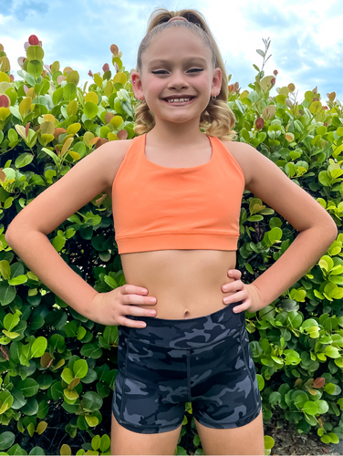 The Youth Peachy Shorts are high-waisted in color black camo with a 75% nylon, 25% spandex blend. Extra stretchy fabric provides extra comfort while still providing a more fitted appearance.