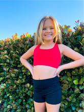 Load image into Gallery viewer, Youth red sports bra with simple design on the front and cute criss cross back