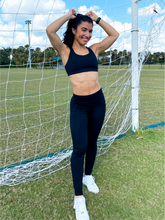 Load image into Gallery viewer, Young lady modeling black buttery soft leggings in black with two side pockets