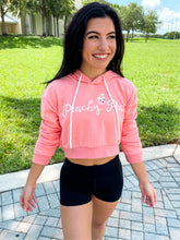 Load image into Gallery viewer, Young lady modeling Peachy Pia Peachy Shorts. Peachy Shorts are high-waisted in color black with a 75% nylon, 25% spandex blend. Extra stretchy fabric provides extra comfort while still providing a more fitted appearance.