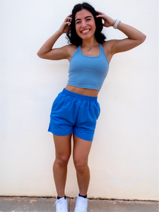Young lady modeling comfortable Blue Sweatshorts in a lightweight material.