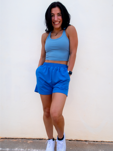 Young lady modeling comfortable Blue Sweatshorts in a lightweight material.