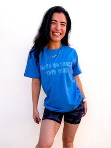Blue graphic t-shirt with a whimsical "happy go lucky type vibe" design.