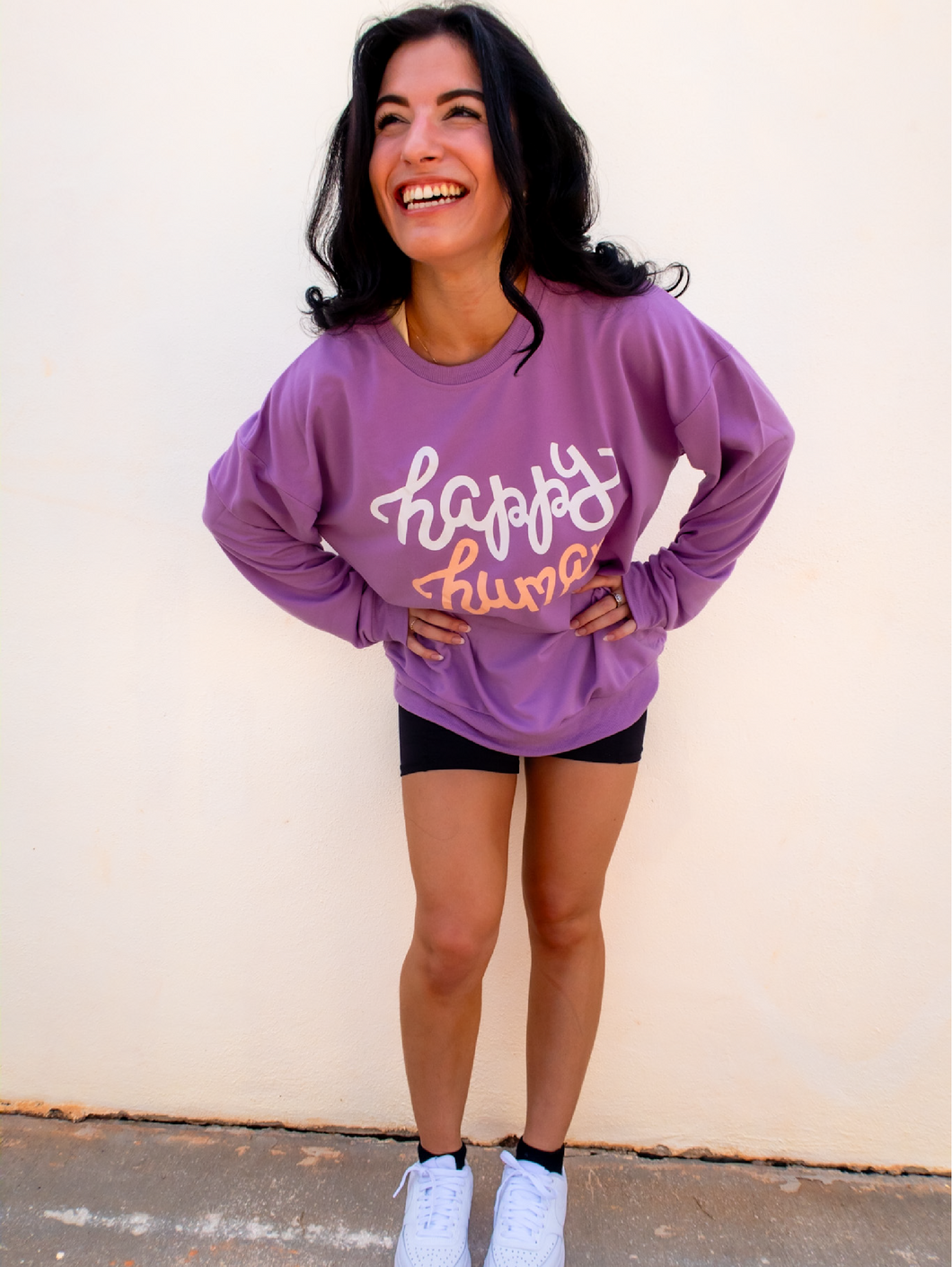 Young lady modeling a purple lightweight, crewneck sweatshirt with a hand-lettered script design saying 