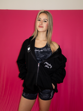 Load image into Gallery viewer, Oversized black zip up hoodie with Stay Peachy on the back with white and pink details
