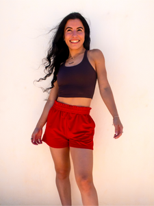 Young lady modeling comfortable red Sweatshorts in a lightweight material.