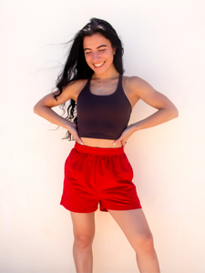 Young lady modeling comfortable red Sweatshorts in a lightweight material.