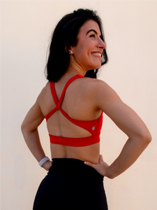 Red sports bra with a simple front, strappy back and light-medium support.