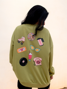 pale green crewneck sweatshirt with the phrase "vintage soul" embroidered across the front and several retro icons printed on the back