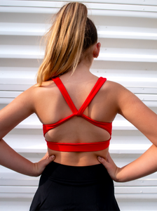 Red sports bra with a simple front, strappy back and light-medium support.