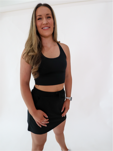 The Complimentary SweatSkirt has an outer skirt built with an elastic waistband and pockets. The Skirt has built-in spandex shorts and a happy message on the tag. Skirt is in color black.
