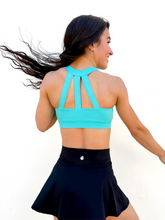 Load image into Gallery viewer, Lady modeling turquoise sporta bra with strappy back.
