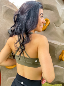 Army green sports bra with medium support, removable pads and a criss cross back
